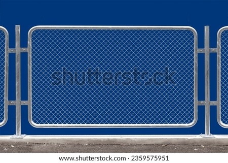 Chain link fencing isolated on blue background. Royalty-Free Stock Photo #2359575951