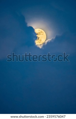 The moon in blue clouds