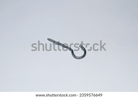 Explore the intriguing world of hanging screws in this photograph set against a clean white background. The image highlights the unique design and purpose of these suspended screws.