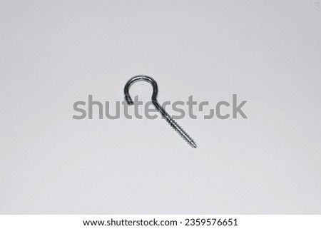Explore the intriguing world of hanging screws in this photograph set against a clean white background. The image highlights the unique design and purpose of these suspended screws.