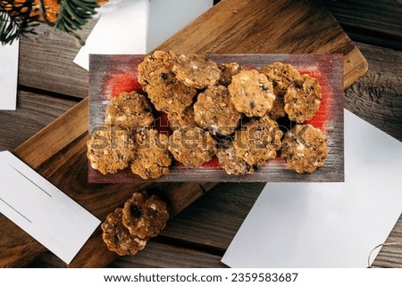 Gingerbread cookies. Rustic Christmas table decorated with wooden planks and red Christmas balls. Top view, macro