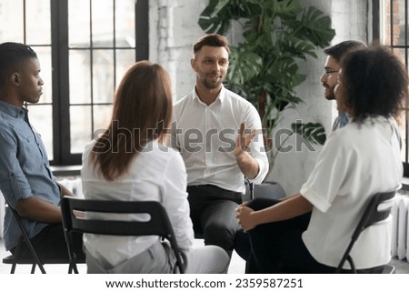 Multiracial young people sit in circle take part in team psychological mental session or treatment, diverse addicts or friends participate in group counseling therapy, talk share thoughts experiences Royalty-Free Stock Photo #2359587251