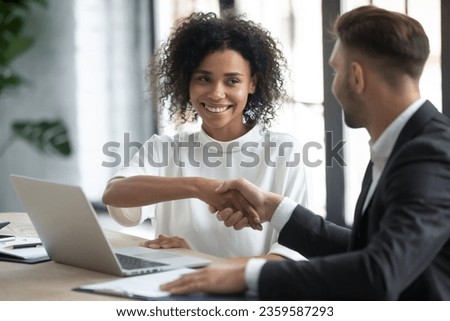 Smiling multiethnic business partners shake hands get acquainted greeting at office meeting, happy diverse colleagues businesspeople handshake close deal agreement at briefing, acquaintance concept Royalty-Free Stock Photo #2359587293