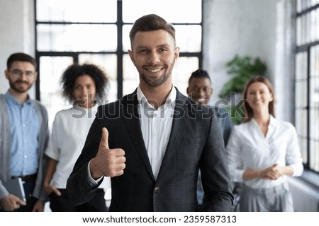 Portrait of smiling confident Caucasian businessman forefront shot thumb up give recommendation, happy motivated male leader boss recommend good company service, leadership, success concept Royalty-Free Stock Photo #2359587313