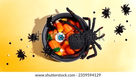 Halloween decorations with witch cauldron - overhead view flat lay Royalty-Free Stock Photo #2359594129