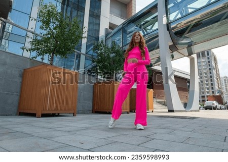 beautiful girl in a bright pink suit
