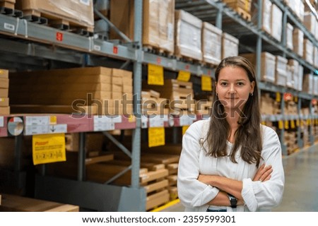 Portrait of woman customer or store worker with shelves in storage as background. High quality photo
