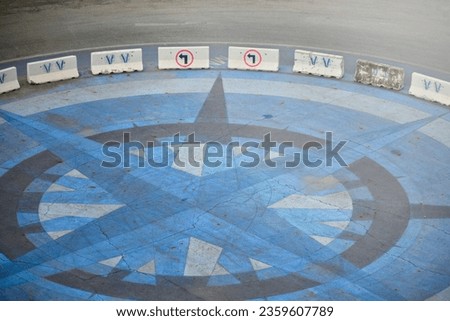 Road traffic signs and barriers, large road roundabouts paved with beautiful tile patterns on a soft sunlight background.