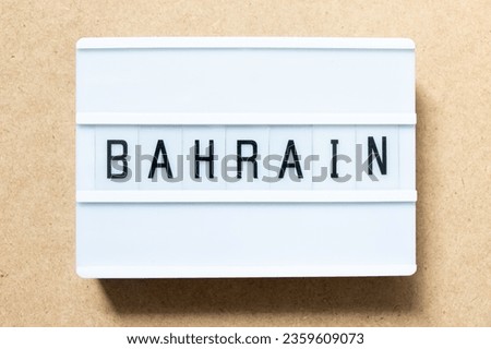 Lightbox with word bahrain on wood background