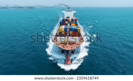 Aerial front view of cargo maritime ship with contrail in the ocean ship carrying container and running for export concept technology freight shipping by ship forwarder mast