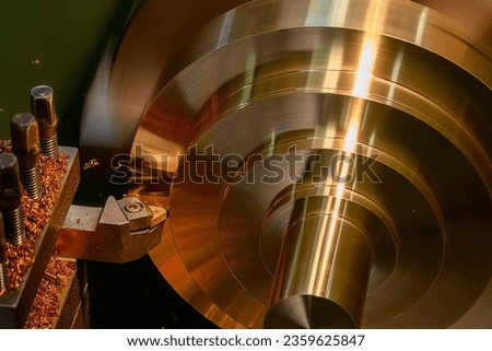 Closeup scene the lathe machine finish cut the brass parts by lathe tools. The metalworking process by turning machine. Royalty-Free Stock Photo #2359625847