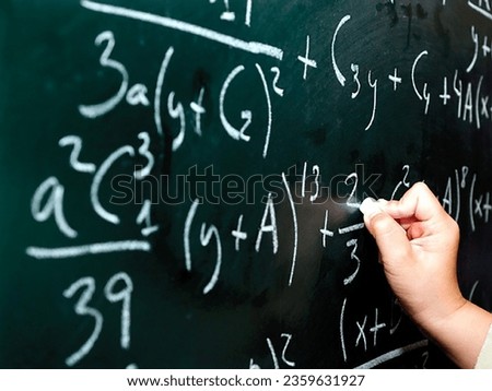 A man is solving maths problem on background with white chok by hand |Learning mathematics picture  Royalty-Free Stock Photo #2359631927
