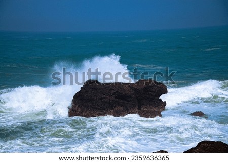 A panoramic view of rocky coastline hits by the wave. Menganti Beach, Indonesia