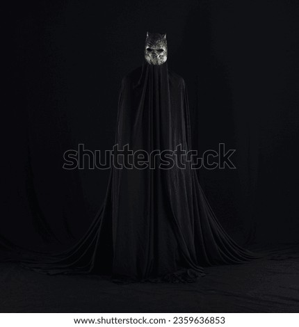 devil in a black cloak on a black background