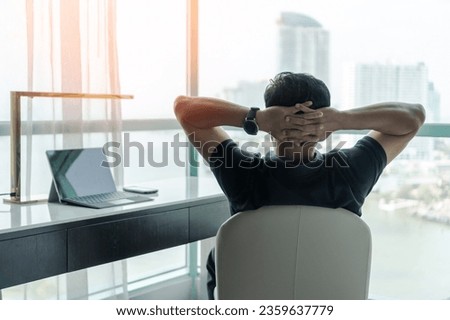 Life-work balance and living life style concept of businessman relaxing, take it easy in hotel or office room resting with thoughtful mind thinking of lifestyle quality looking forward to city Royalty-Free Stock Photo #2359637779