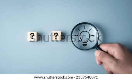Idea creative thinks form  problem solving question concept. Magnifying glass focus on light bulb icon and  questions mark icon on wooden cube development inspiration discovery solutions to issues. Royalty-Free Stock Photo #2359640871