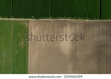 aerial photo shot of mixed cultivated and harvested rural plain land during hot season