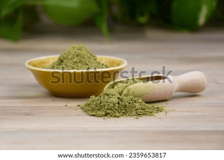Kratom Mitragyna speciosa powder stock images. Green kratom and wooden scoop still life stock photo. Kratom herbal medicine on a wooden background stock images