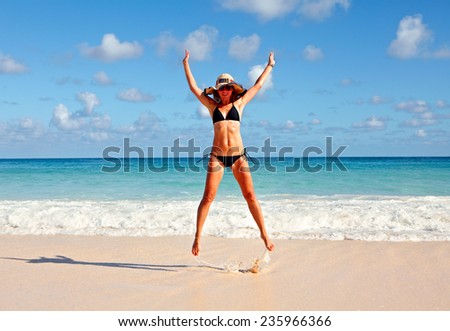 Young Girl jumping on the beach. Summer vacation