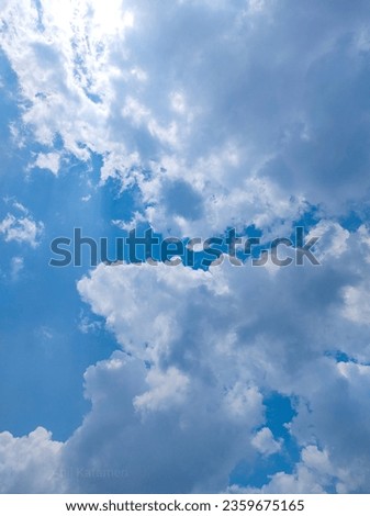 A beautiful picture of a clear blue sky full of pearly white clouds. It was taken from a hilltop in Kerala.