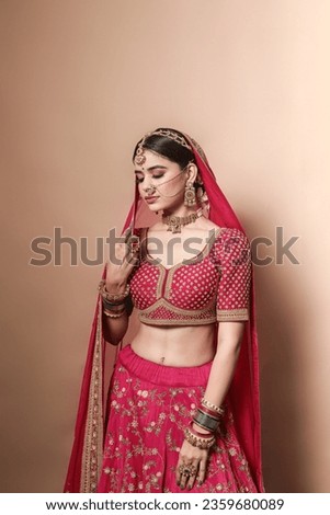 Beautiful Indian bridal in studio shot. 
Magnificent young Indian bride in luxurious bridal  Royalty-Free Stock Photo #2359680089