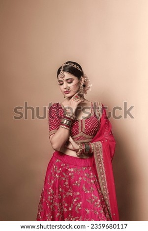 Beautiful Indian bridal in studio shot. 
Magnificent young Indian bride in luxurious bridal  Royalty-Free Stock Photo #2359680117