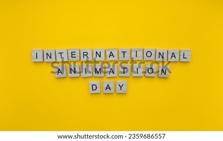 October 28, International Animation Day, minimalistic banner with the inscription in wooden letters