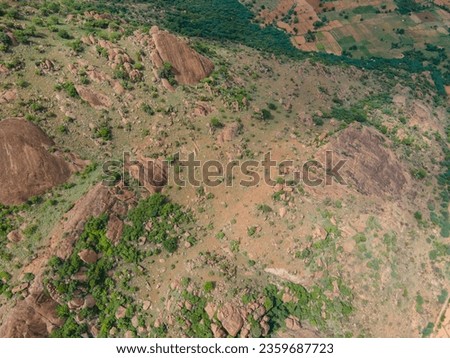 drone shot aerial view top angle bright sunny day cloudy mountainous terrain hills ghat area agricultural region rocks wallpaper background india tamilnadu tourism natural scenery afforestation forest