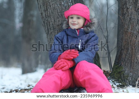 Girl in the park winter snow walk