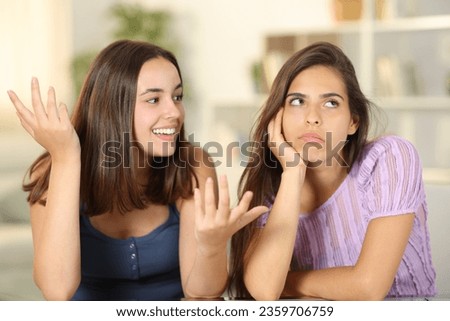 Woman ignoring the conversation of her friend at home Royalty-Free Stock Photo #2359706759