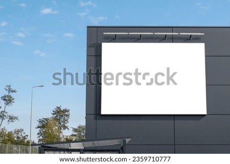 Blank white advertising banner on the wall of the modern building