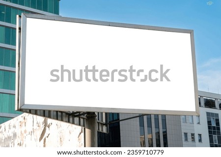 Blank white advertising billboard in front of the modern office building