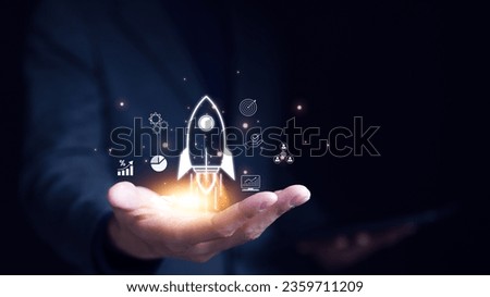 Businessman holding icons about business and investment, Rocketing take off with a targeted launch speed, Wealth fast, Graph depicting rising earning, increasing profits exemplifies financial success, Royalty-Free Stock Photo #2359711209