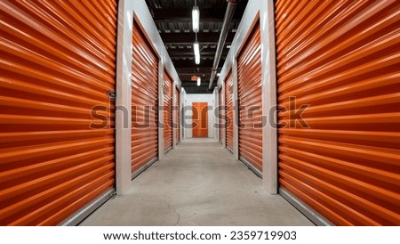 Empty hallway with orange  garage doors of a self storage unit warehouse. Royalty-Free Stock Photo #2359719903