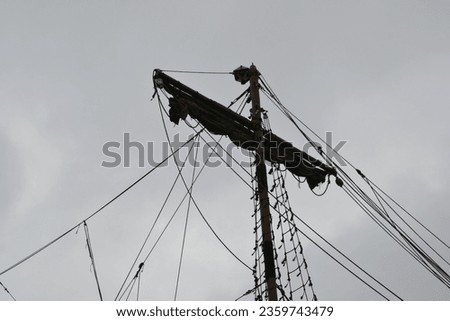 Ship's mast, ship's mast silhouette against the background of a gray sky