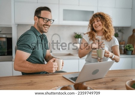 happy couple caucasian adult man and woman husband and wife morning routine use laptop computer during breakfast at home bright photo copy space