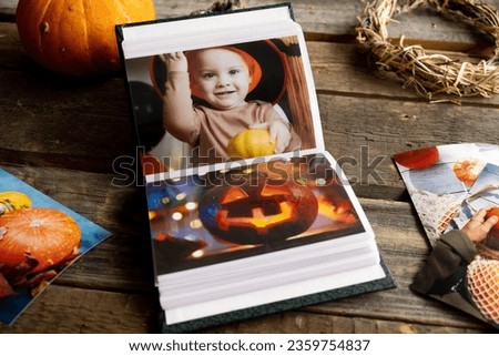 Halloween printed photos in photo album. Photo printing concept.