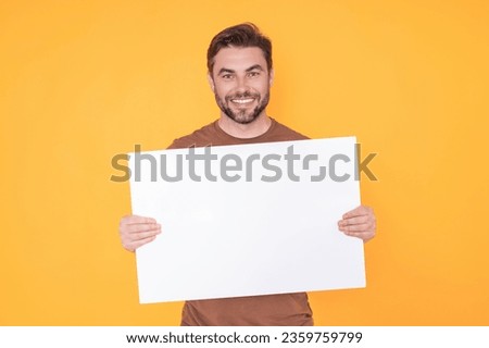 Blank signboard, billboard or banner with copy space. Happy attractive handsome smiling middle aged man showing promo blank board on studio background. Advertisement concept. Blank mockup. Royalty-Free Stock Photo #2359759799