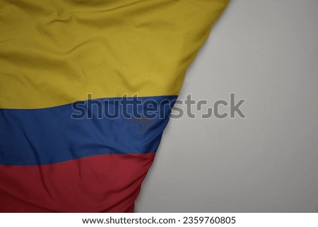 big waving national colorful flag of colombia on the gray background. macro