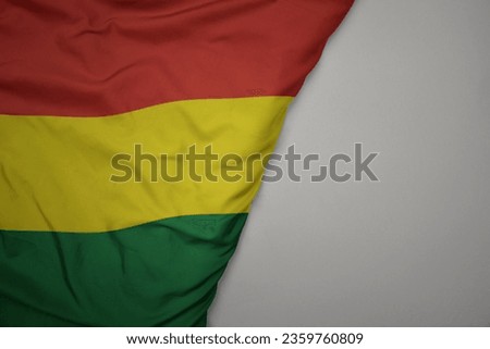 big waving national colorful flag of bolivia on the gray background. macro