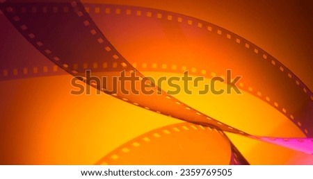 orange yellow color background with film strip. cinematography premiere film production show industry concept.abstract background with film strip Royalty-Free Stock Photo #2359769505