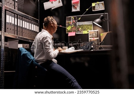 Police investigator reading witness testimony and looking at suspect surveillance photos on laptop. Private detective studying information file and searching crime solving insight