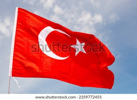 Close-up picture of national red flag of Turkey on blue sky background