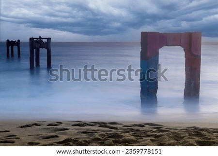 Stormy Skies and Silky Water over Davenport Old Pier. Davenport, Santa Cruz County, California, USA.