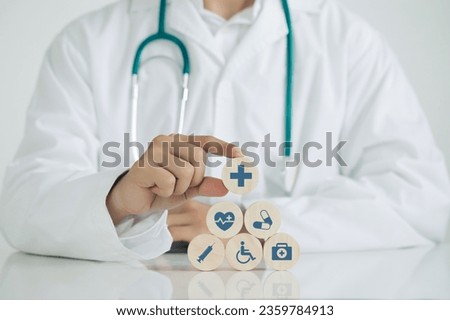 Doctor hand arranging wood block with healthcare medical icons. Healthcare and Medical Insurance concept.Good Healthcare.World Health Day.
