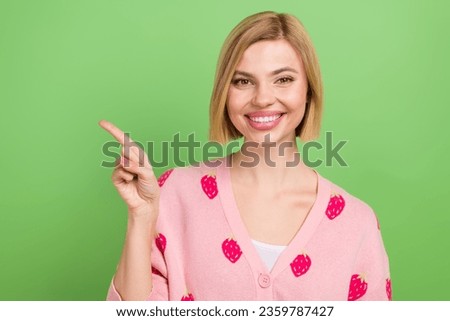 Photo of pretty young girl finger point empty space dressed stylish pink strawberry print outfit isolated on green color background