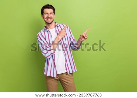 Photo of young handsome guy model directing fingers empty space useful tips how secure your passwords isolated on green color background