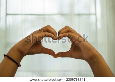 Two hands gesture "love" with white background