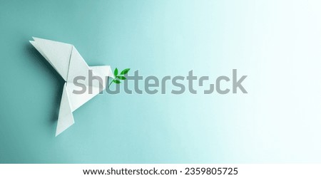 Peace and New Beginnings of Hope. A white dove Flying over the Blue background Holds an Olive Branch. World International Peace Day. The Concept of a Fluttering Bird that brings Peaceful to the World Royalty-Free Stock Photo #2359805725