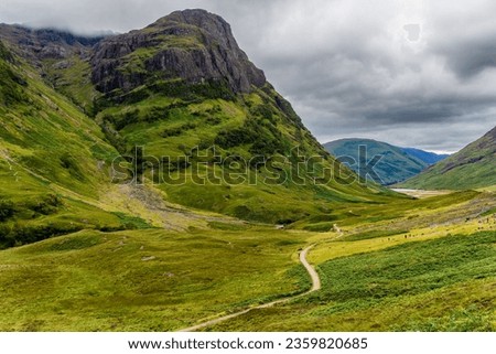 Spectacular mountain scenery with a stormy, grey sky in Glencoe, Scotland Royalty-Free Stock Photo #2359820685